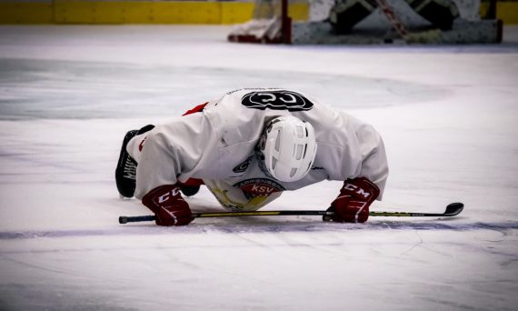 A focused ice hockey player warming up on the rink, showcasing determination and skill.